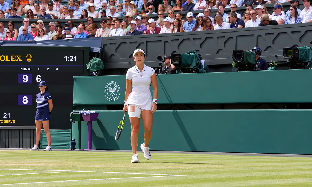 Alex Eala on court at Wimbledon in the sunshine